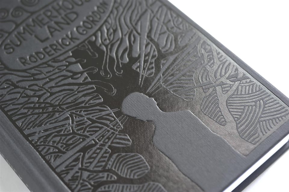 Close-up of the illustration blocked into the black Wibalin board, lit to reveal the impression.