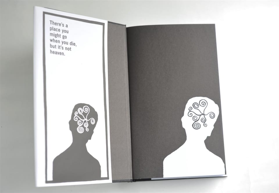 The book opened flat to show the printed endpapers, each bearing a silhouetted figure.